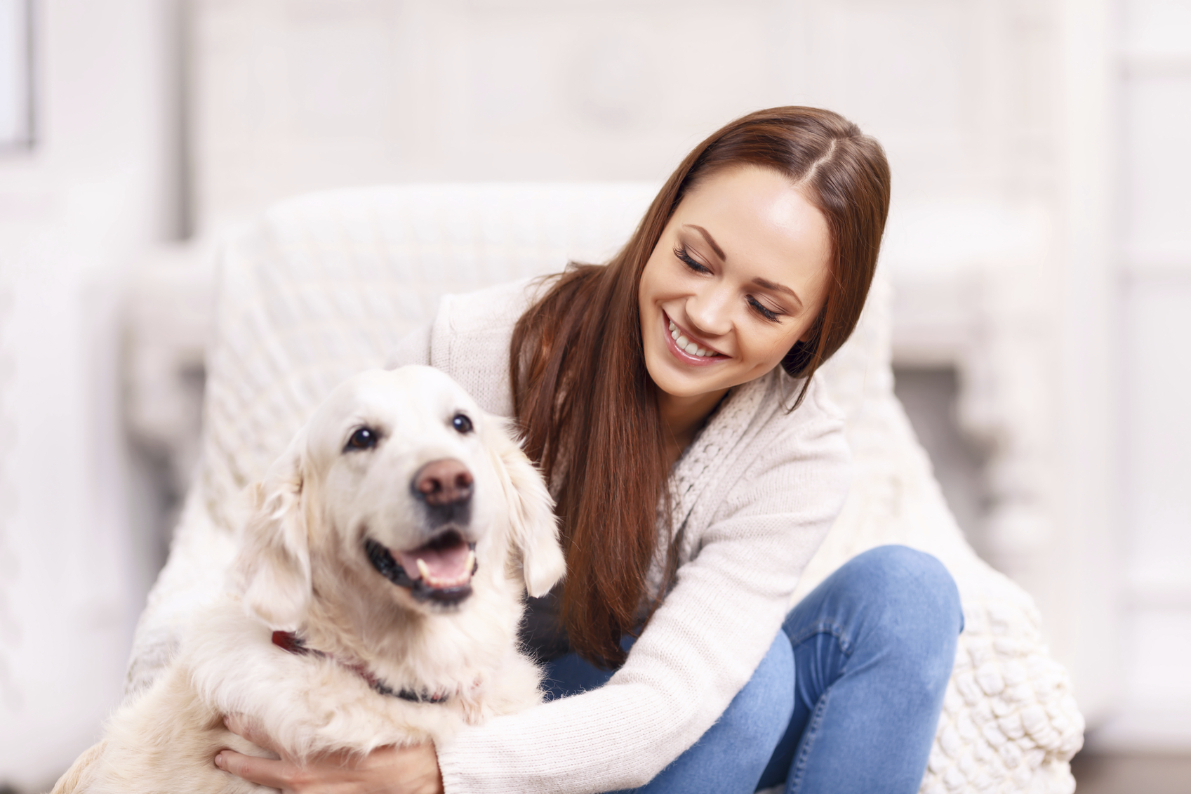 Young girl patting her pet dog